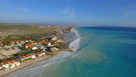 big waves damaging houses after a hurricane passed by at the coastline of bonaire