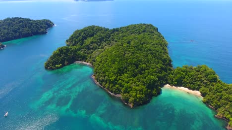 inclinándose hacia abajo para ver las hermosas aguas turquesas alrededor de la isla tropical afuera isla frente a la costa de panamá en américa central