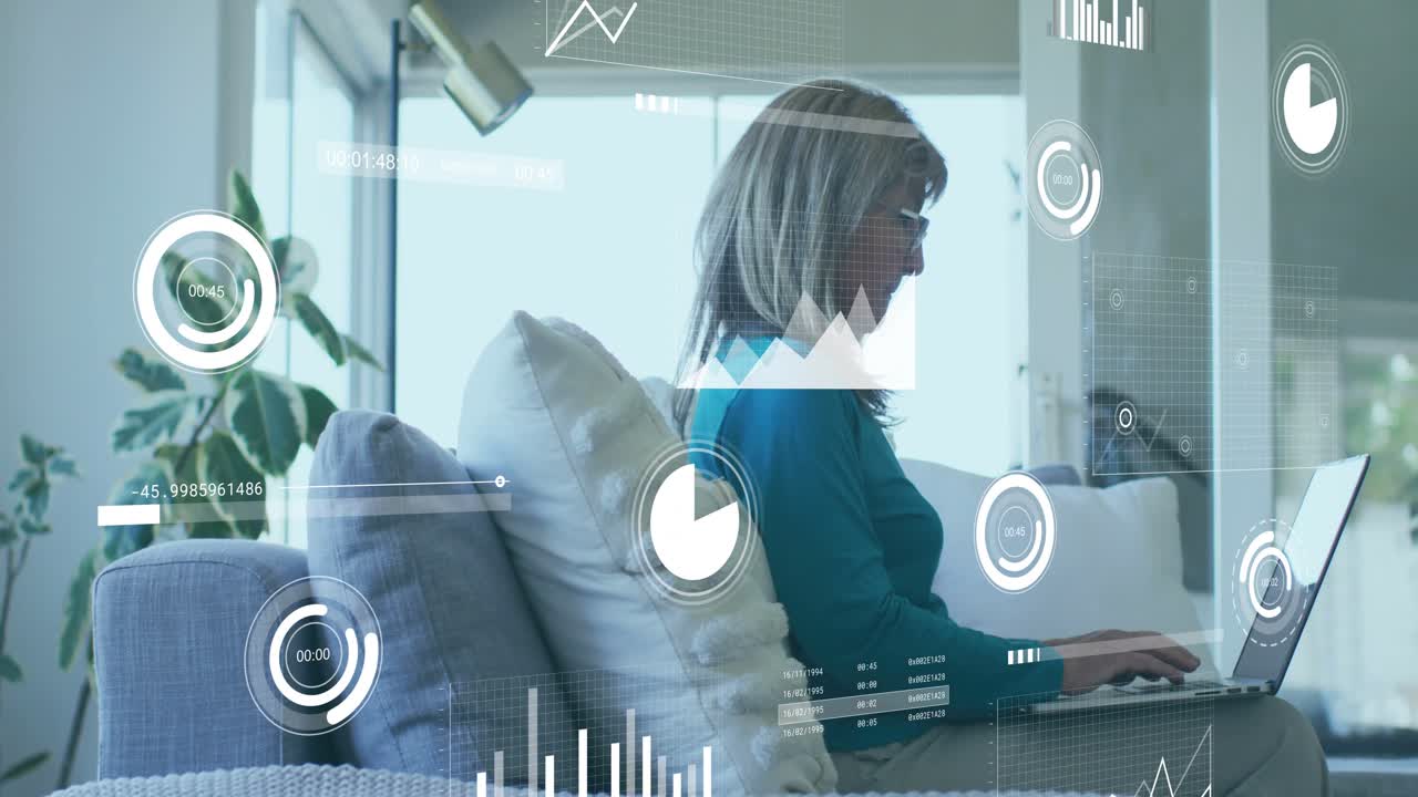 Senior woman opening laptop and typing while monitoring business analytics with animated overlays