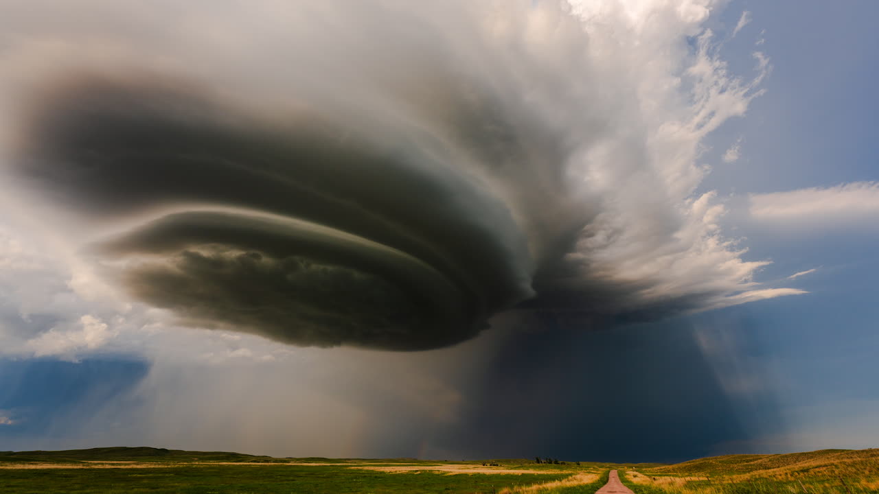 Pretty storm clouds spin overhead in late evening sun rays