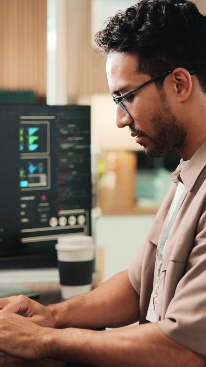 Software Developer Working on Code at Desk