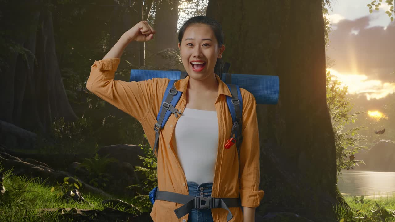 Asian Female Hiker With Mountaineering Backpack Smiling And Flexing Her Bicep While Exploring Forest Nature