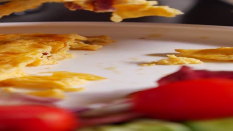 close up of an omelet with tomatoes and vegetables