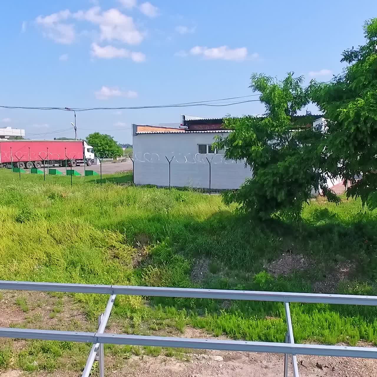 Building of innovative solar power station in nature. Metal basis for future solar panels on the field. Motion camera back.