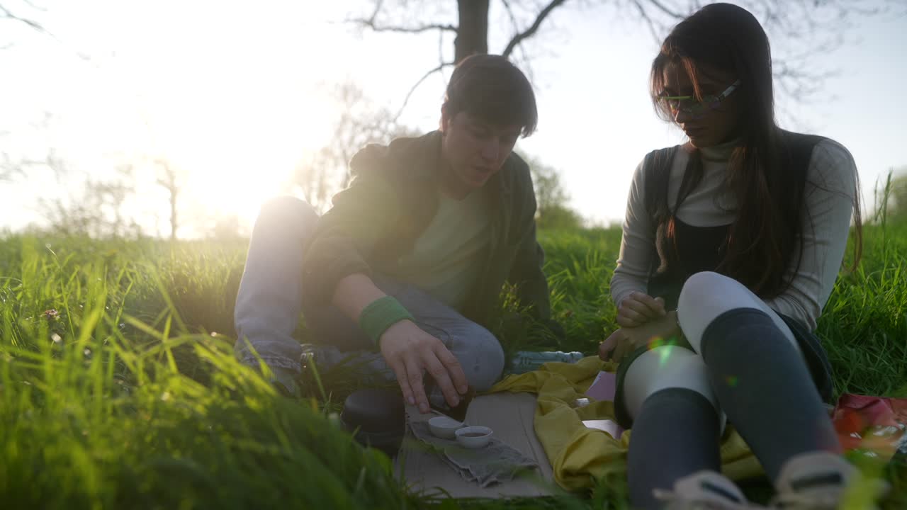 Couple enjoying tea outdoors during sunset