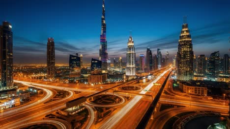 nighttime cityscape of dubai with illuminated highways and skyscrapers