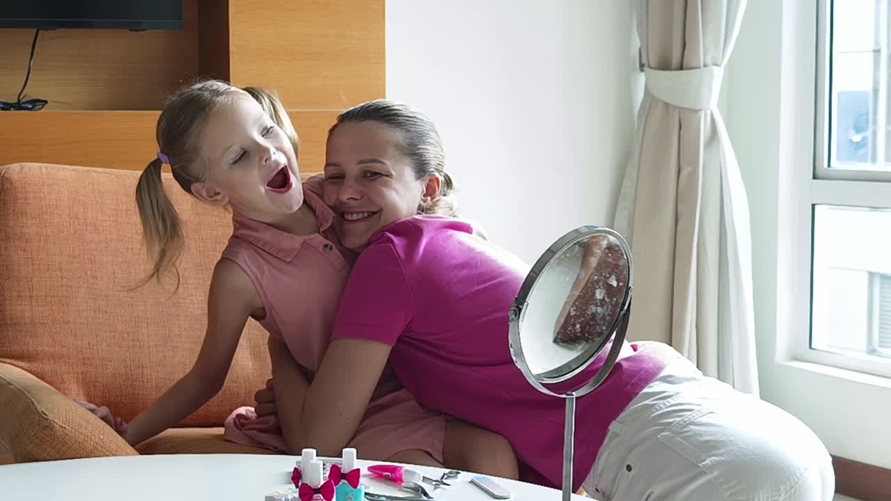 어머니 와 딸 이 집 에서 재미 있는 활동 을 즐기고 있다