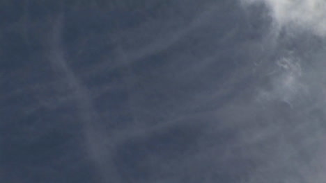 Clouds-pass-directly-overhead-against-a-blue-sky