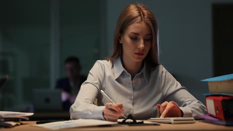 woman working late in a dim office