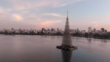 panning around the worlds tallest floating christmas tree of 2018 in rio de janeiro in the middle of the city lake lagoa rodrigo de freitas with an amazing colourful sunset