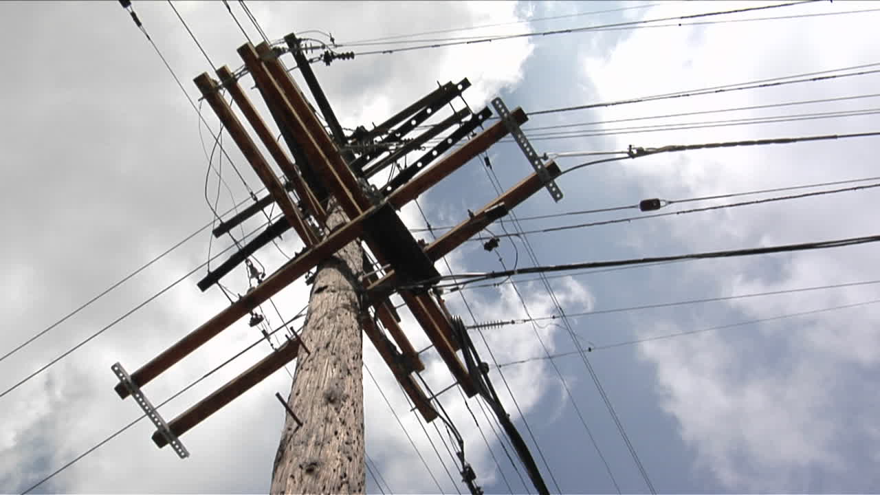 Wires run to a power pole from four directions