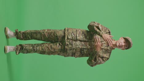 full body of wondering asian man soldier saying why and standing doubtfully in the green screen background studio