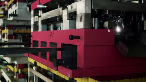 a big metal tool for shaping car parts being loaded and lifted by a forklift for transport from a warehouse to the factory