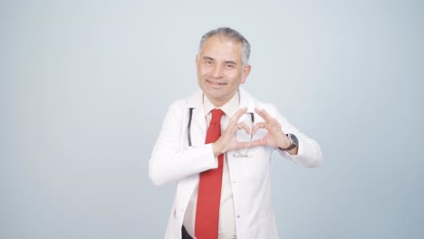 doctor making heart looking at camera.