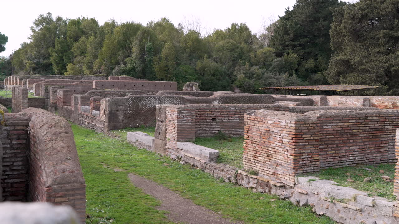 Archaeological remains of commercial buildings at the ancient Roman port city of Ostia Antica.
