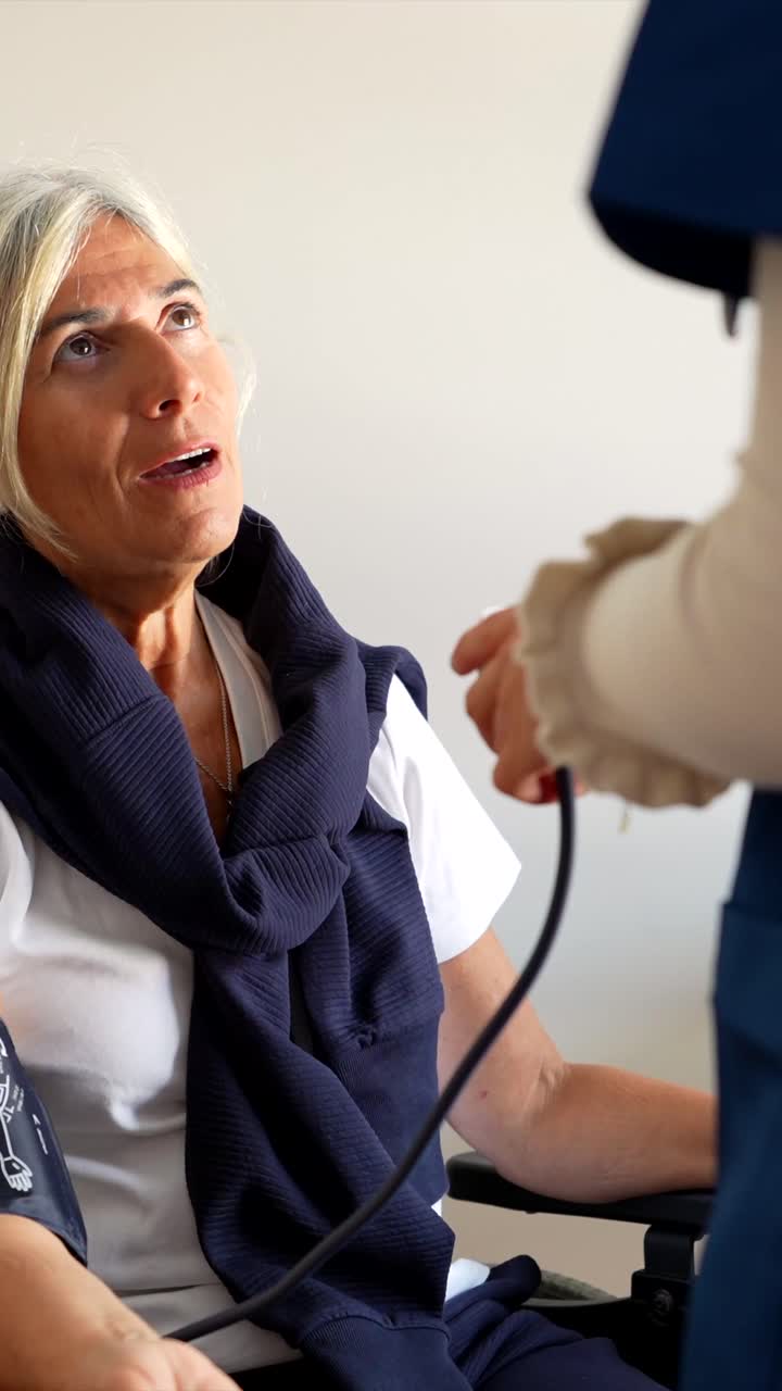 Senior woman having blood pressure checked by a nurse