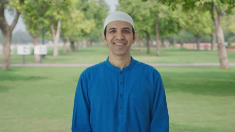 happy muslim man smiling to the camera in park