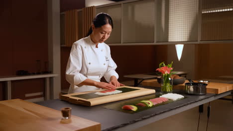 a chef prepares sushi rolls with tuna and avocado