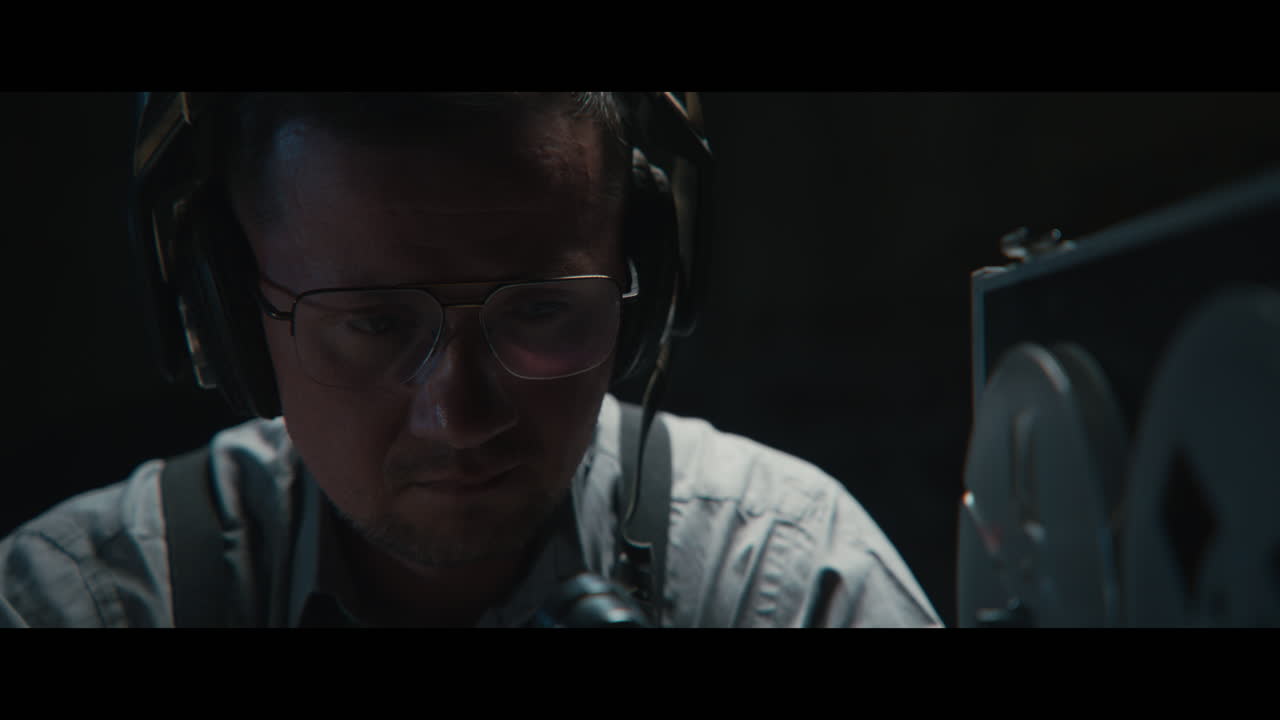 An intelligence officer listens to the wiretap recordings