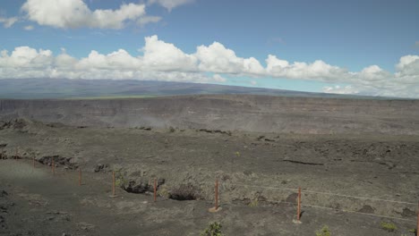 steam and smoke rising from volcano crater with picturesque clouds in the sky