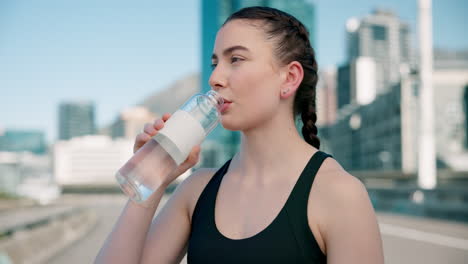 City,-fitness-and-woman-drinking-water