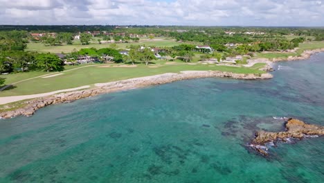 seaside golf course with crystal-clear blue water of caleton de la majagua bay in casa de campo, dominican republic