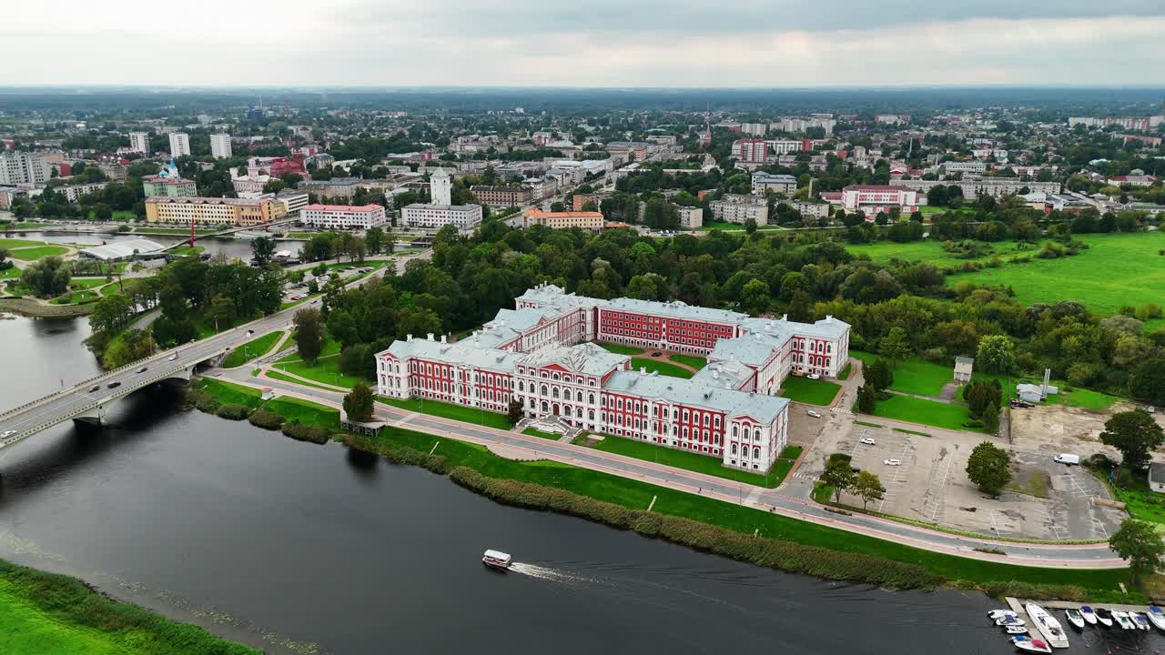 Aerial view of Jelgava Palace by the river in Latvia, showcasing nature and history