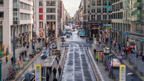 timelapse view of pedestrians, trams and general traffic on friedrichstrasse street in central berlin, germany, zoom out