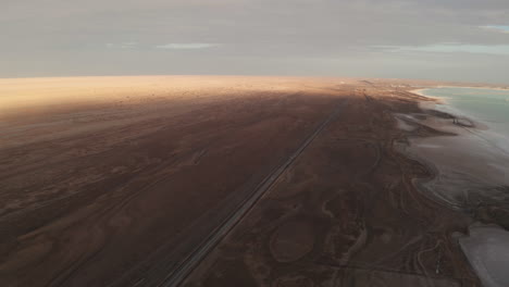 straight road by the salt lake with wide flatlands background.