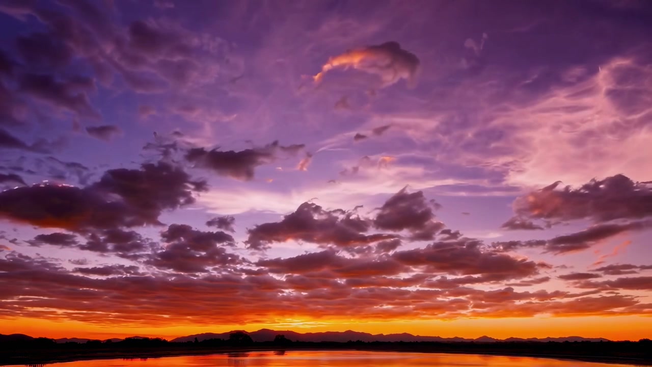 Time Lapse of a Vibrant Sunset Over a Calm Lake