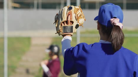 Diverse-group-of-female-baseball-players-in-action-on-the-field,-returned-ball-caught-by-pitcher