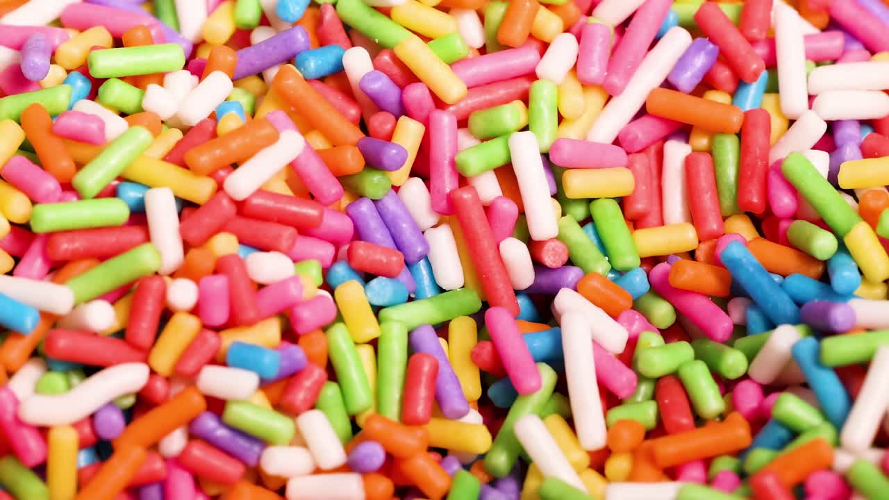 A vibrant close-up view of colorful sprinkles creating a lively and dynamic pattern.