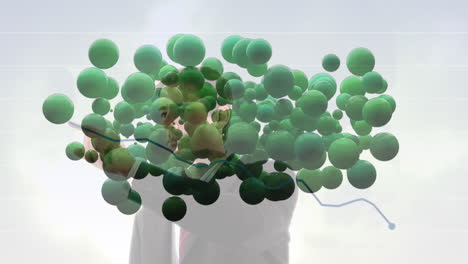 animación de bolas verdes sobre un empresario caucásico escribiendo un gráfico