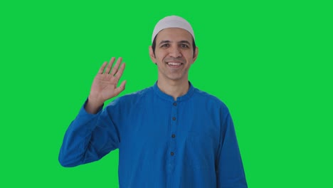 happy muslim man saying hello green screen