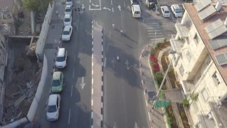 Aerial-clip-of-children-racing-downhill-in-the-streets-of-Jerusalem-Israel