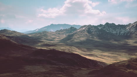 Red-brown-slopes-and-snow-capped-mountain-peaks