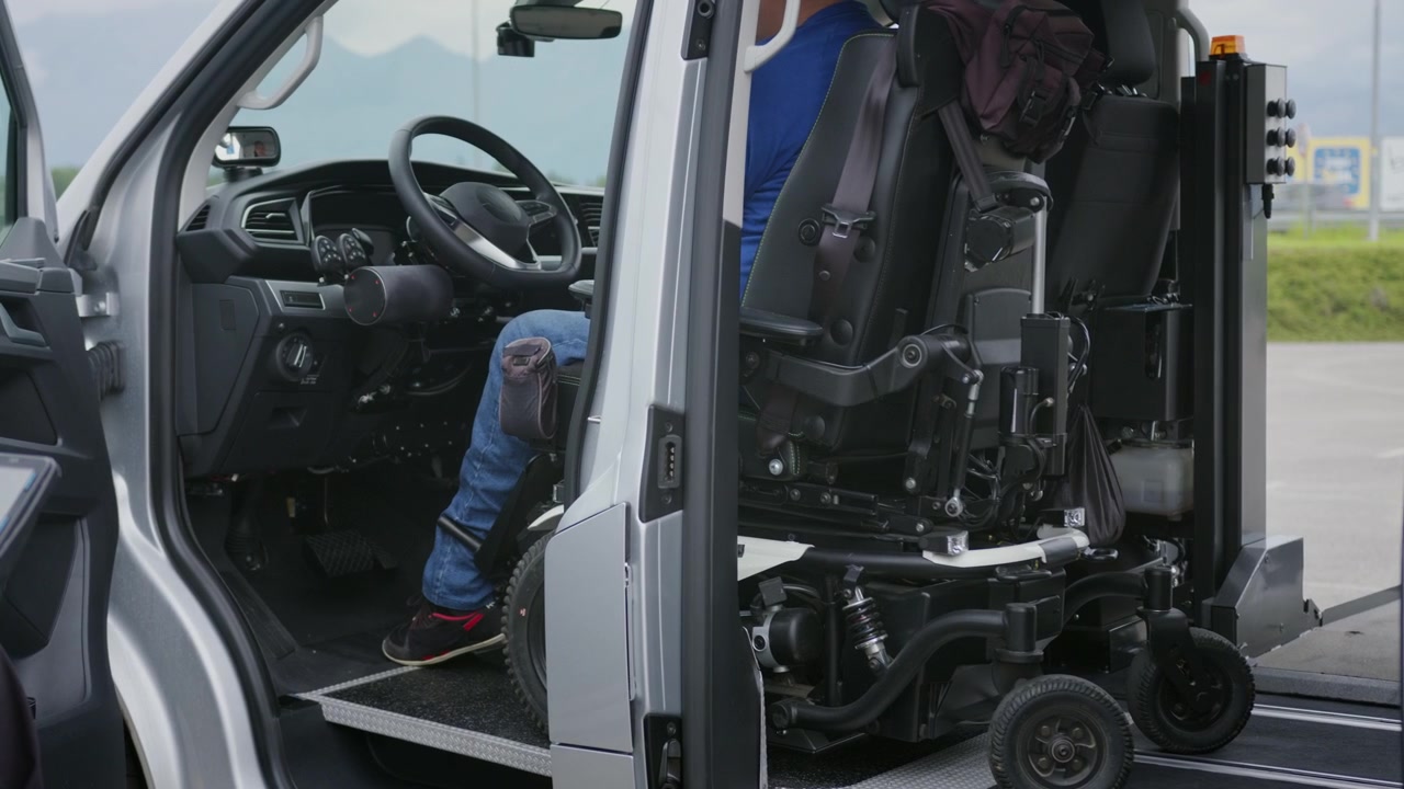 Powered wheelchair user positioning a wheelchair in the driving position of an accessible vehicle