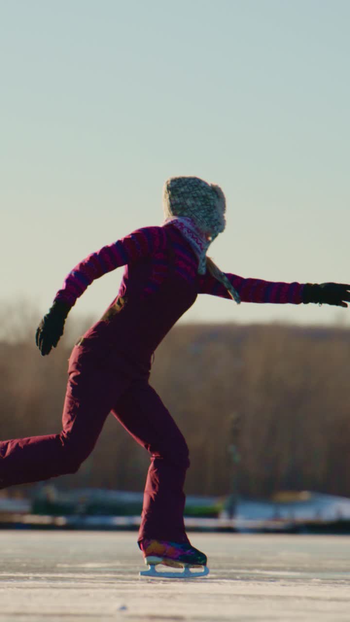 A graceful skater glides effortlessly across a frozen lake, embodying the elegance of ice skating while dressed warmly for winter's chill, showcasing skill and poise in the serene outdoor setting