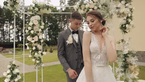 newlyweds, caucasian groom with bride walking, embracing, hugs in park, wedding couple