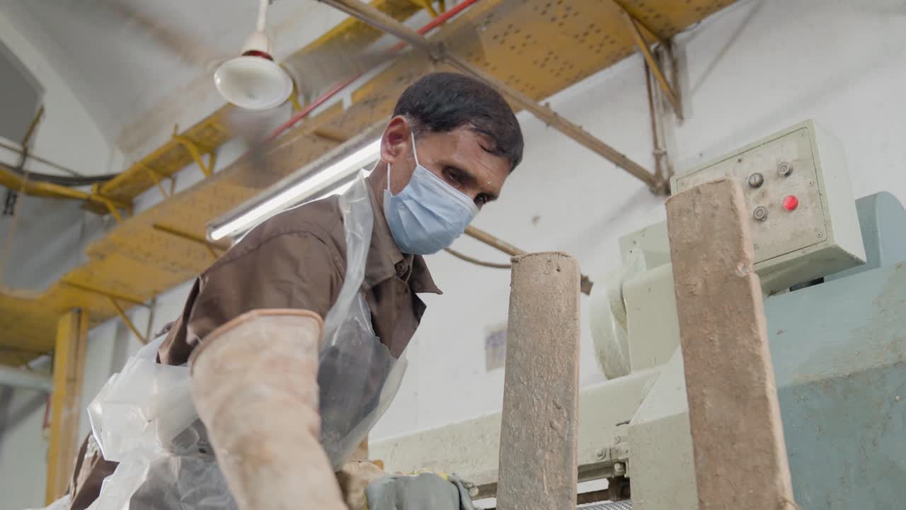 Portrait Of A Leather Factory Worker Working On The Production Line Manufacturing Textiles.