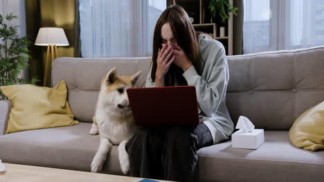 woman sitting next to her dog