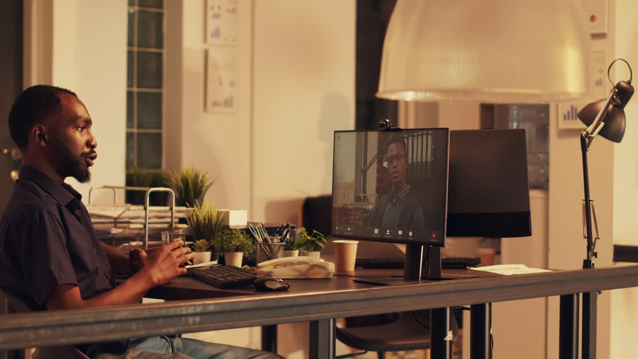 Male manager attending videocall conference with worker