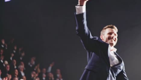 businessman celebrates success on stage