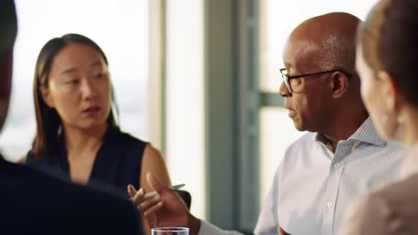 a group of professionals engages in a thoughtful discussion about innovative strategies for business growth.