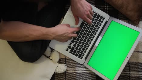a person works remotely. green laptop screen. selective soft focus. the concept of distance education. surfing the internet. top view.