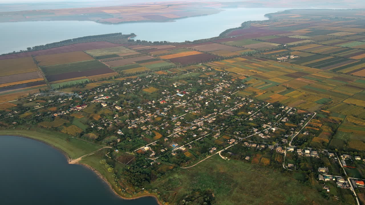 Aerial drone view of the Duruitoarea natural reservation in Moldova. River and fog in the air, hills and fields, village