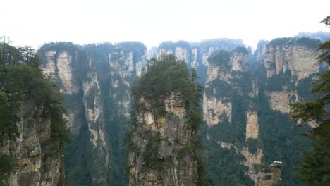 misty avatar hallelujah mountain peaks in zhangjiajie national park with lush greenery, likely shot during the day, aerial view