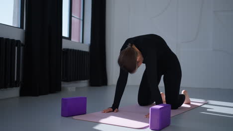 woman practicing yoga in a studio