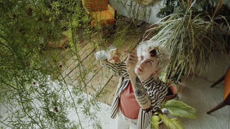 female florist examining asparagus plant