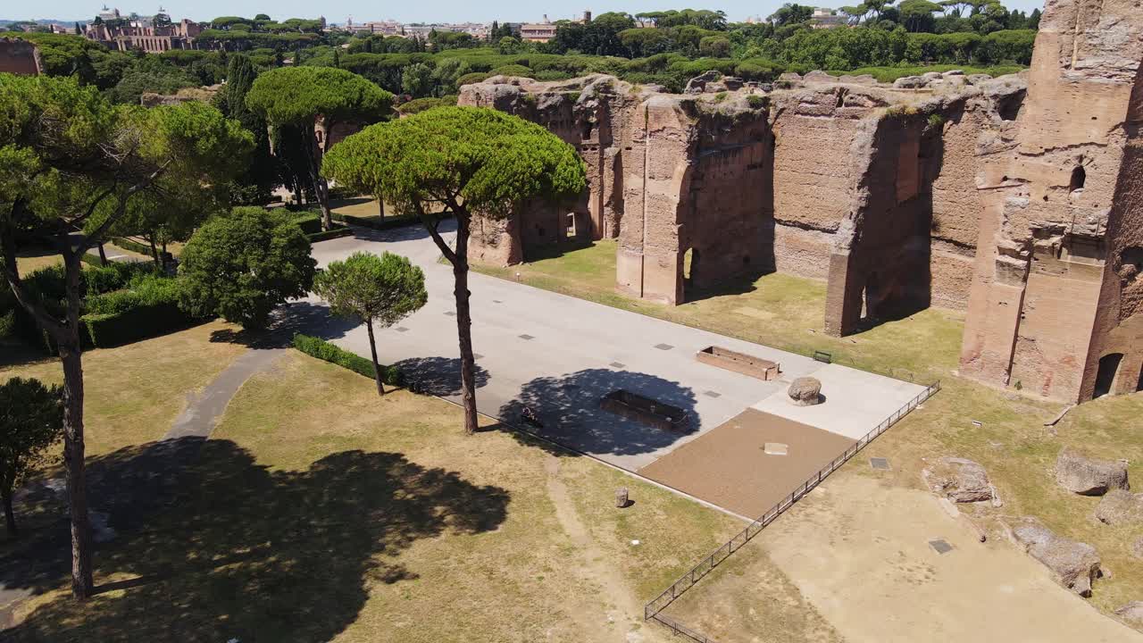 Aerial view of historic Roman spa complex bathed in intense summer sunshine